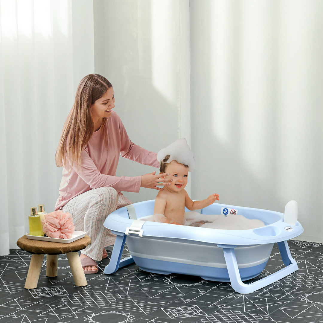 ZONEKIZ Foldable Baby Bath Tub, Bath Tub with Non-Slip Support, Cushion Pad, Drain Plugs, Shower Head Holder, for Newborn to 6 Years - Blue | Aosom UK