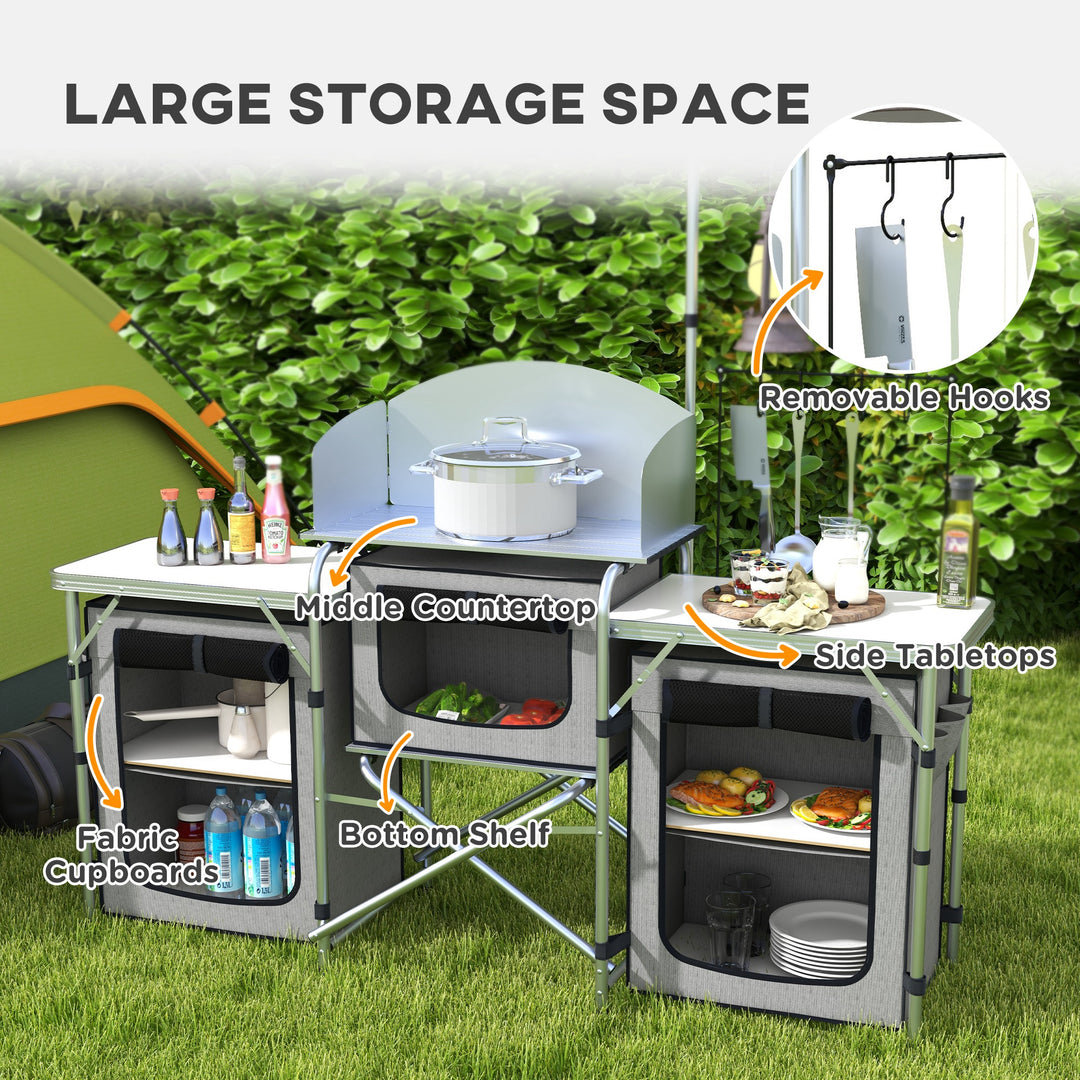 Outsunny Compact Camping Kitchen, Aluminium Portable Outdoor Cooking Station with Windshield, Storage Cupboards & Carry Bag for BBQ, Silver