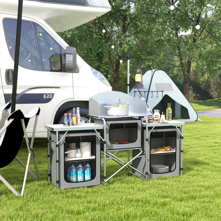 Outsunny Compact Camping Kitchen, Aluminium Portable Outdoor Cooking Station with Windshield, Storage Cupboards & Carry Bag for BBQ, Silver